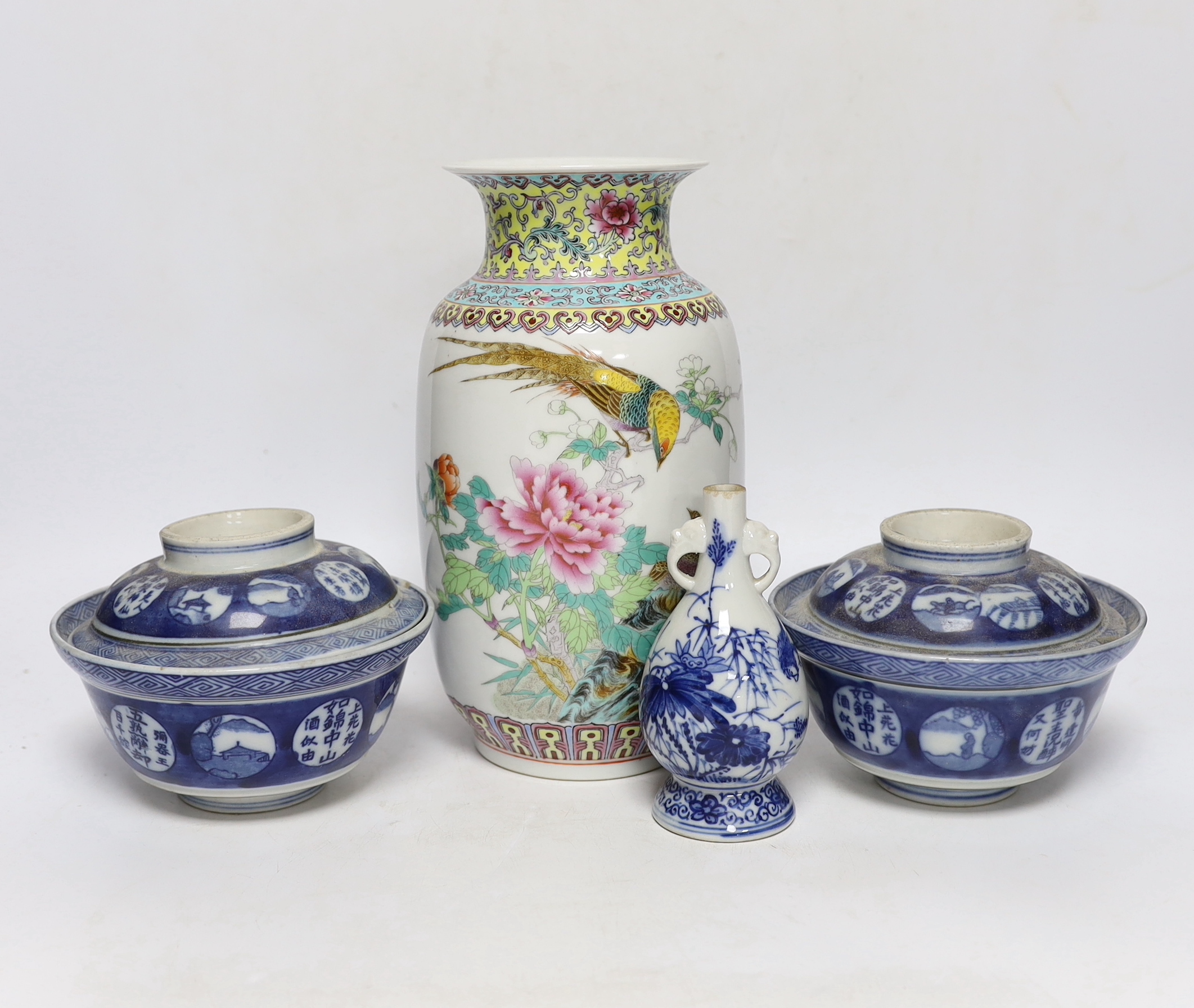 A Chinese famille rose vase, two Japanese blue and white rice bowls and covers and a Japanese blue and white vase (4) tallest 24.5cm